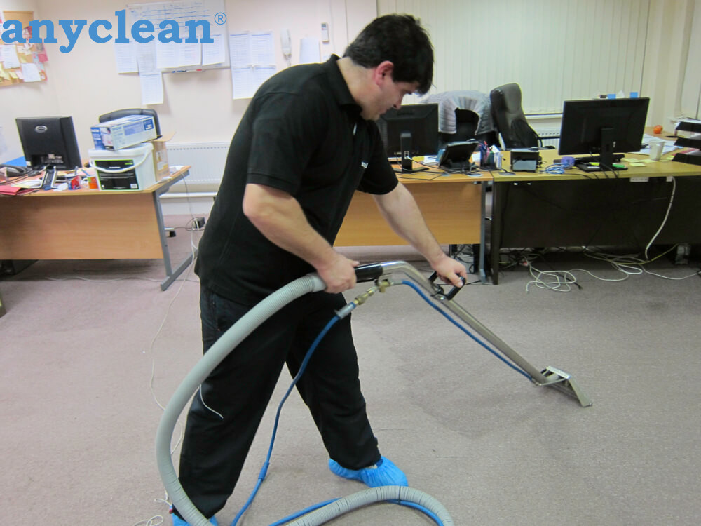 Anyclean technician carrying out professional carpet cleaning