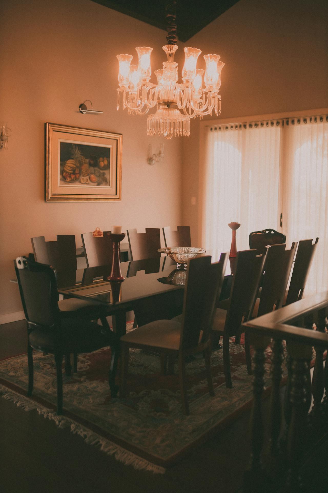 A dining room with a chandelier over the table