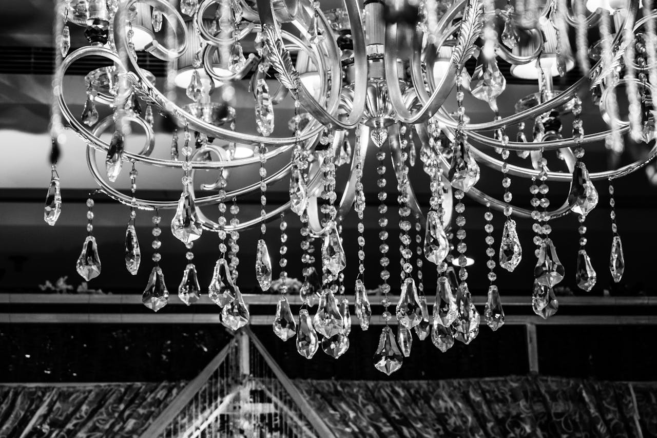 A close-up greyscale shot of a crystal chandelier