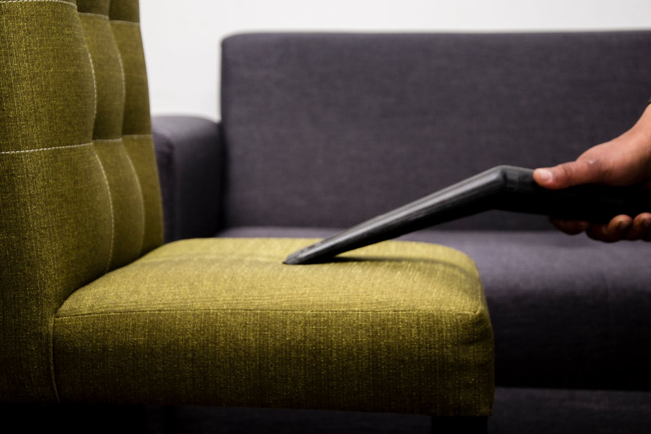 Vacuuming an upholstered chair