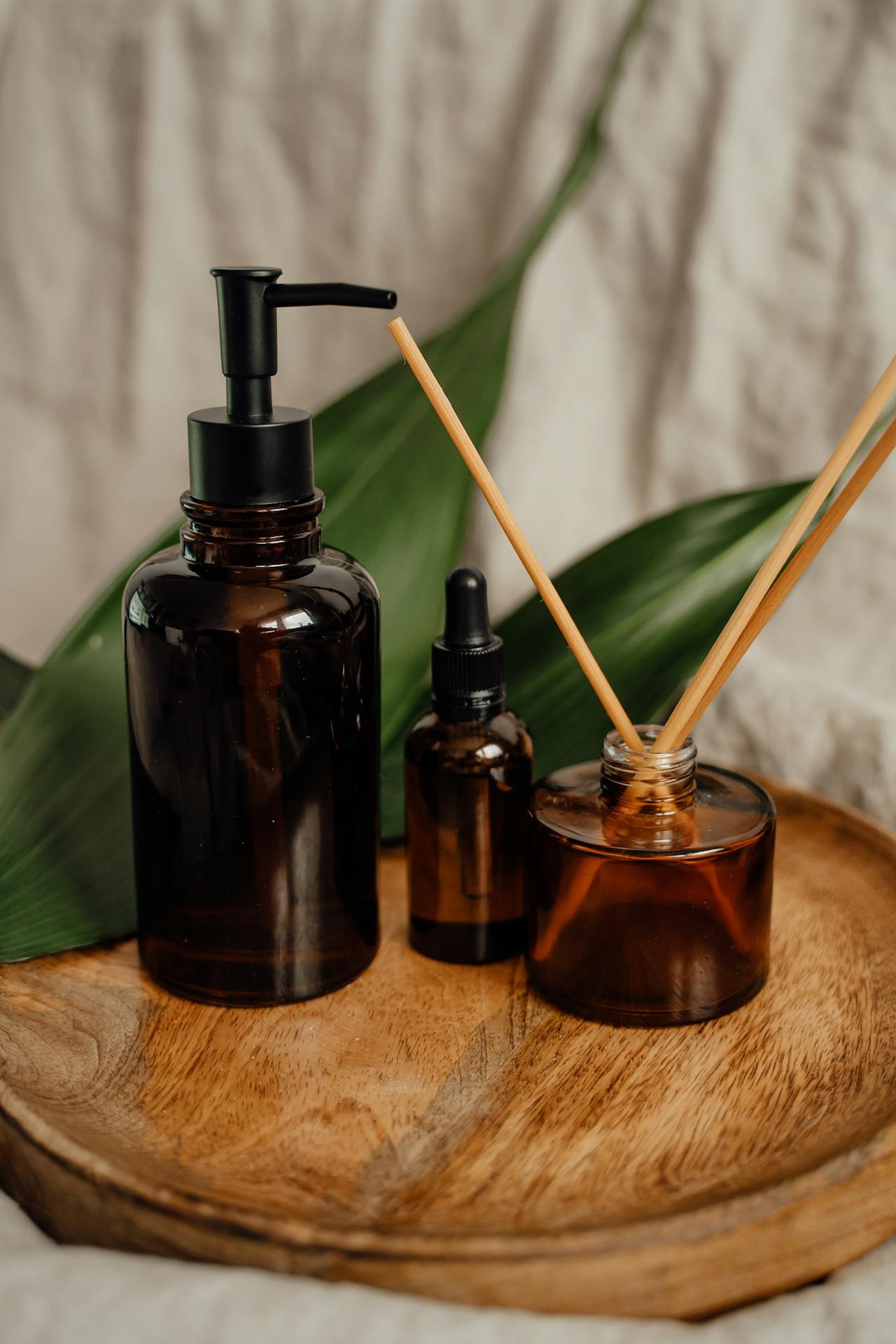 Pump-up bottle and aroma sticks on a wooden board