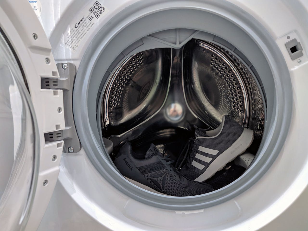 A close-up shot of the inside of a white washing machine