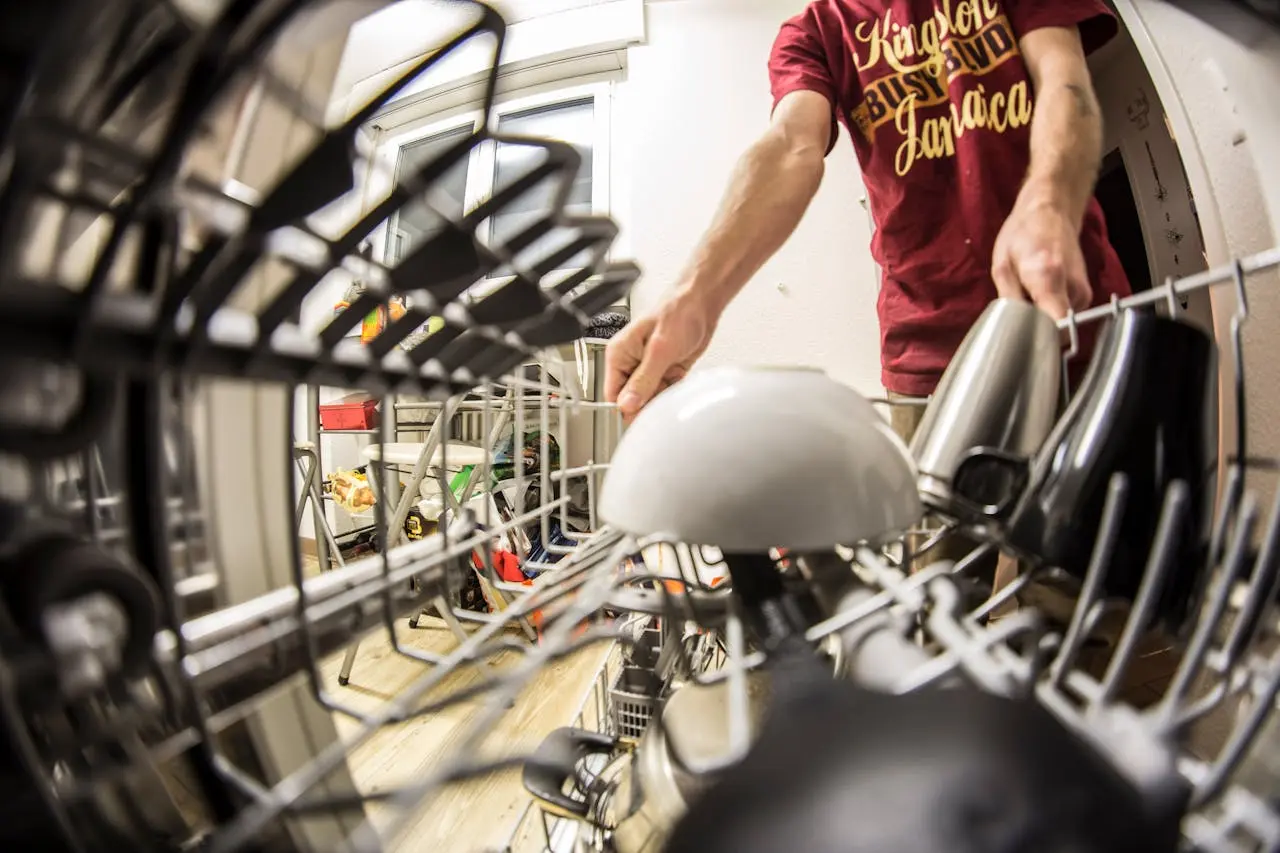 A close-up shot of a man loading his dishwasher