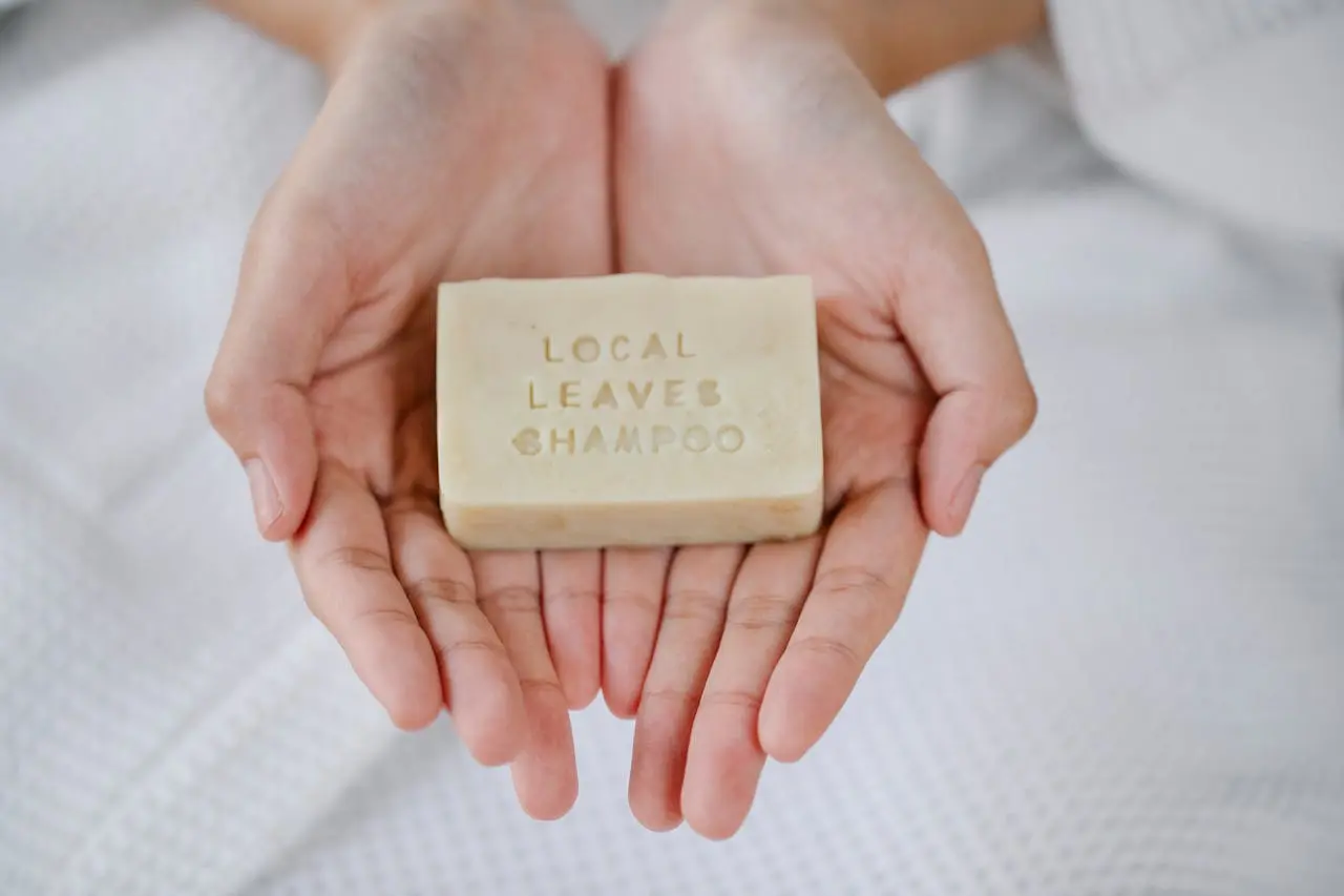 A woman holding a branded bar of organic soap