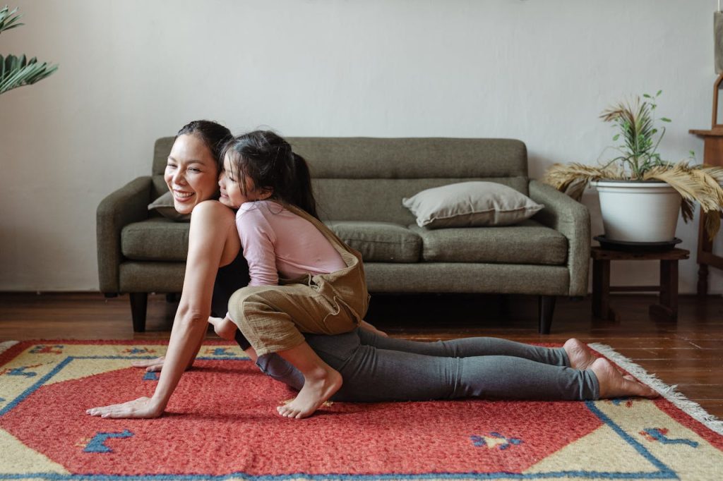 A woman doing yoga with her child at home