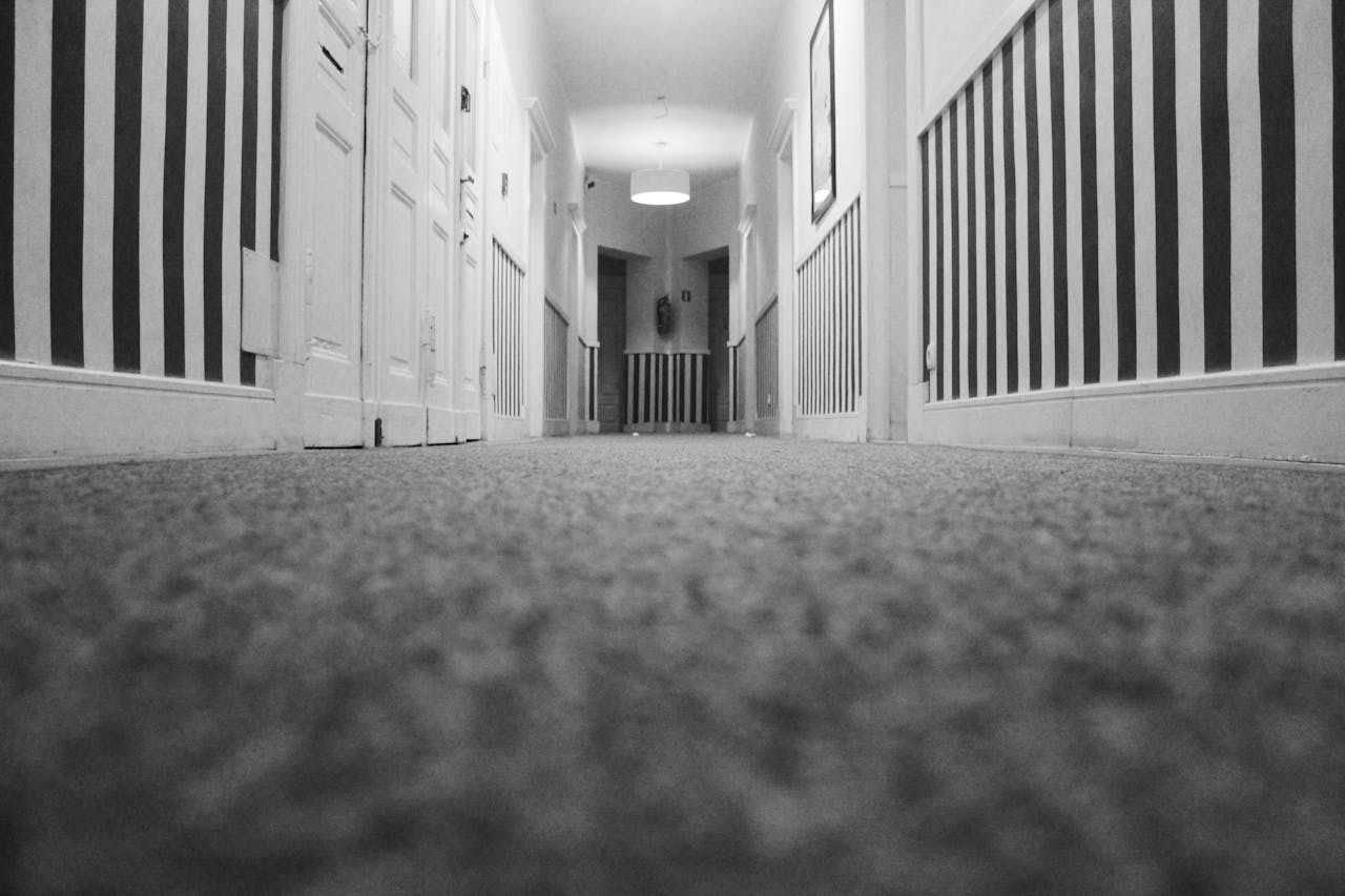 Low-angle image of a hallway carpet
