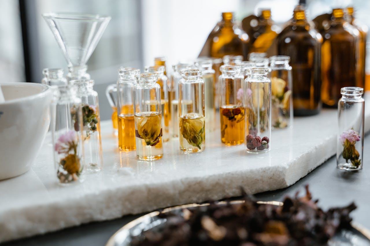 A row of small glass containers of various essential oils