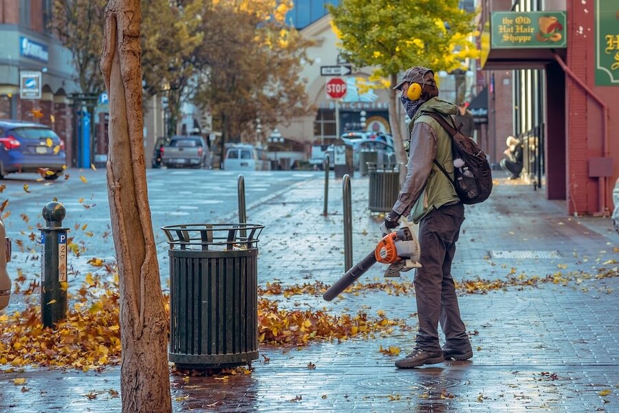 guy-blowing-leaves-with-a-leaf-blower A Guy Blowing Leaves with a Leaf Blower