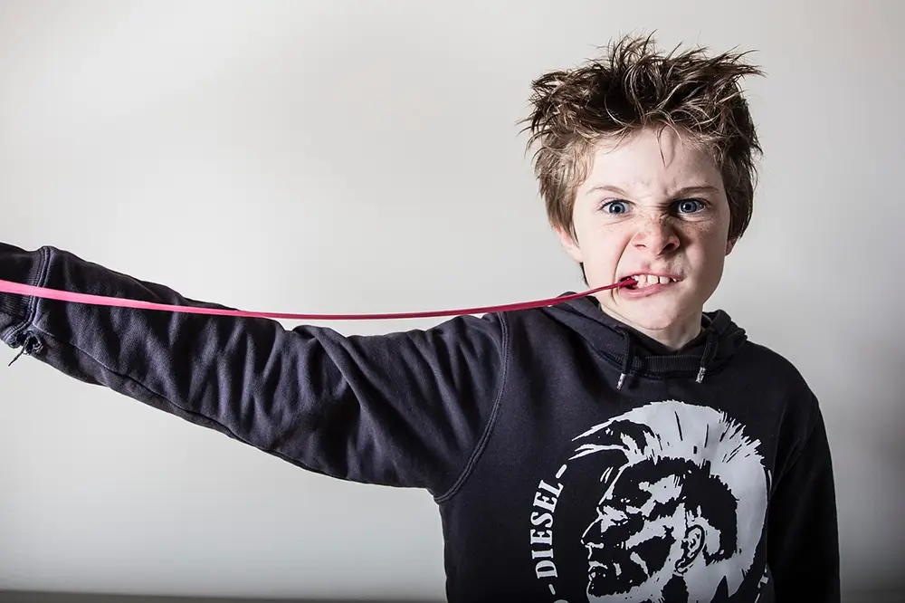 Boy Chewing Gum and Grimacing