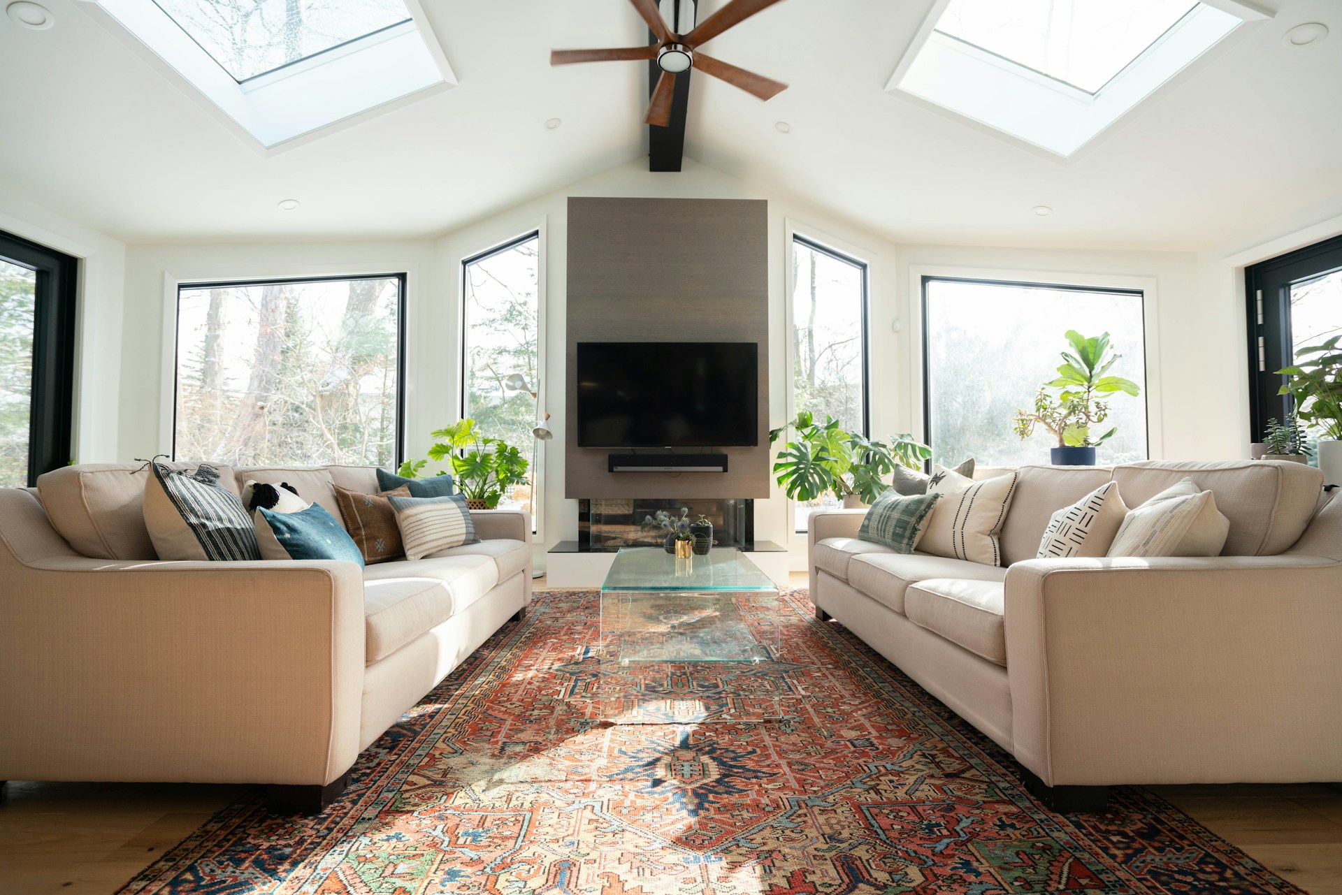 A multi-colour carpet in the middle of a sunny, spacious living room
