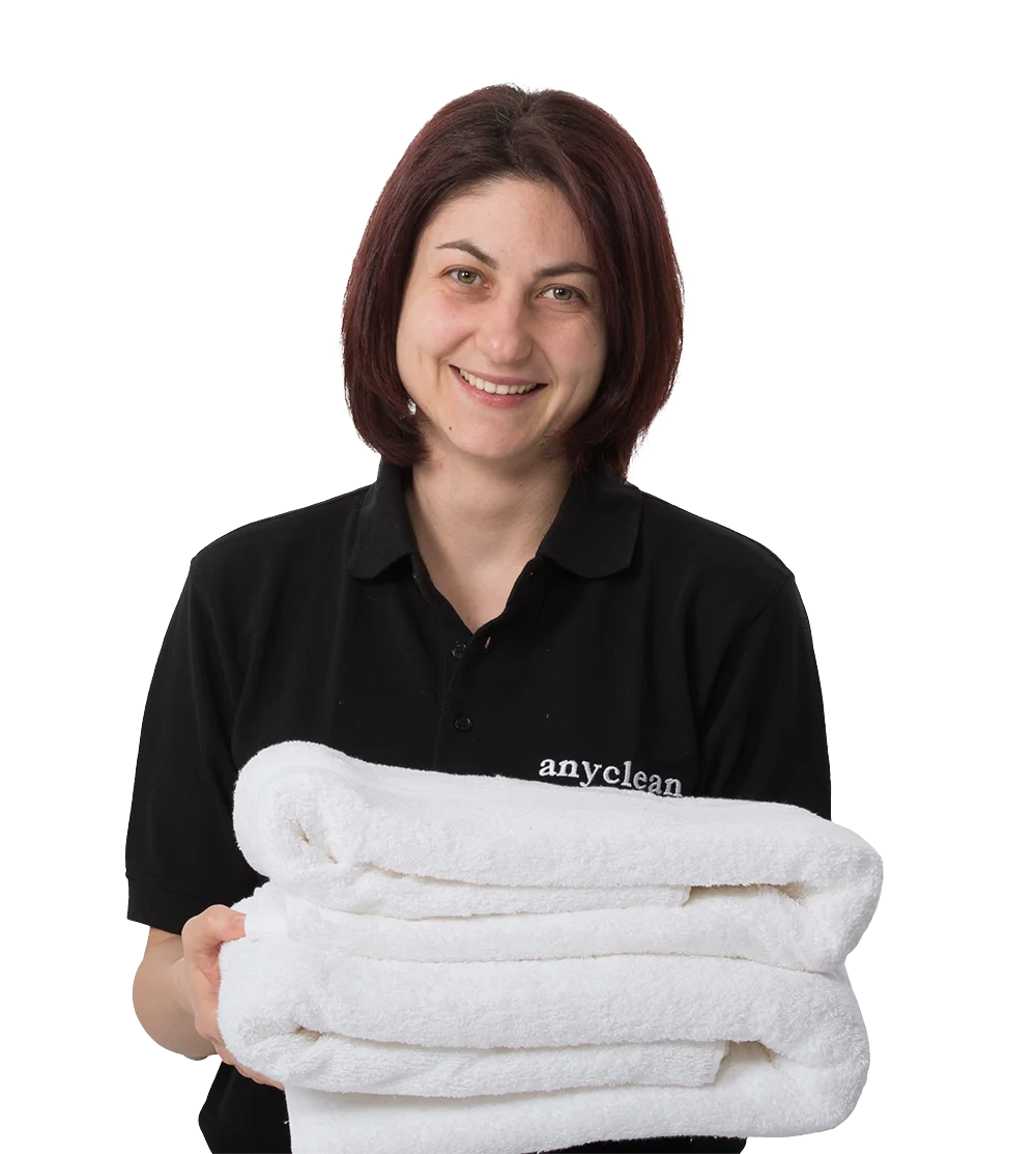 House Cleaning Maid Holding White Towels and Smiling