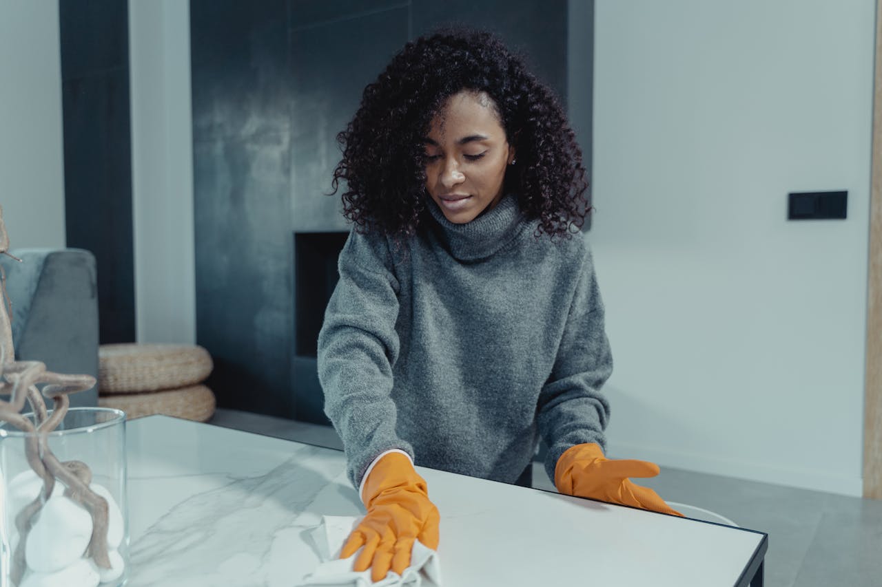home-cleaning-specialists-in-london A London home cleaner polishing a counter top