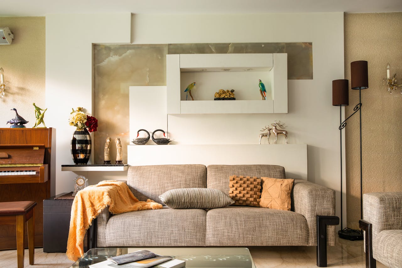 A large double-seat grey upholstered sofa